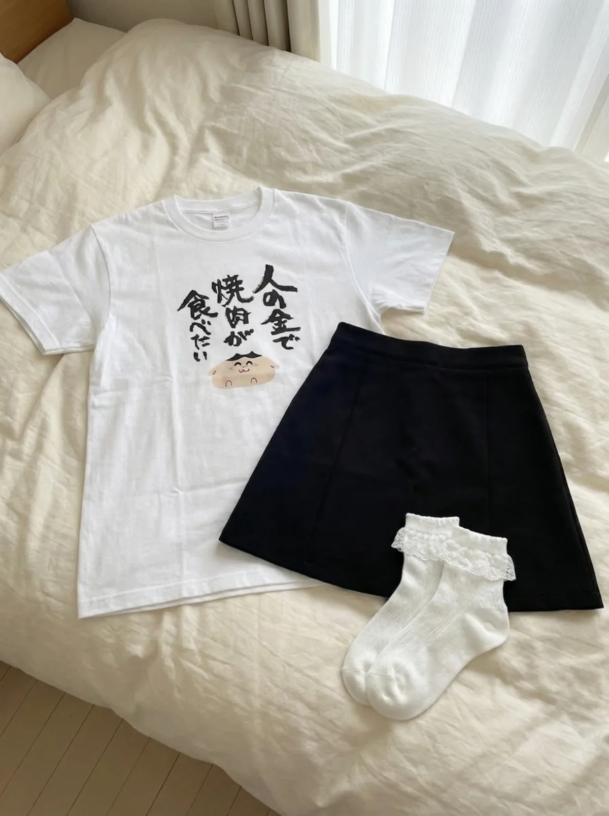 Clothing laid out on bed prompt