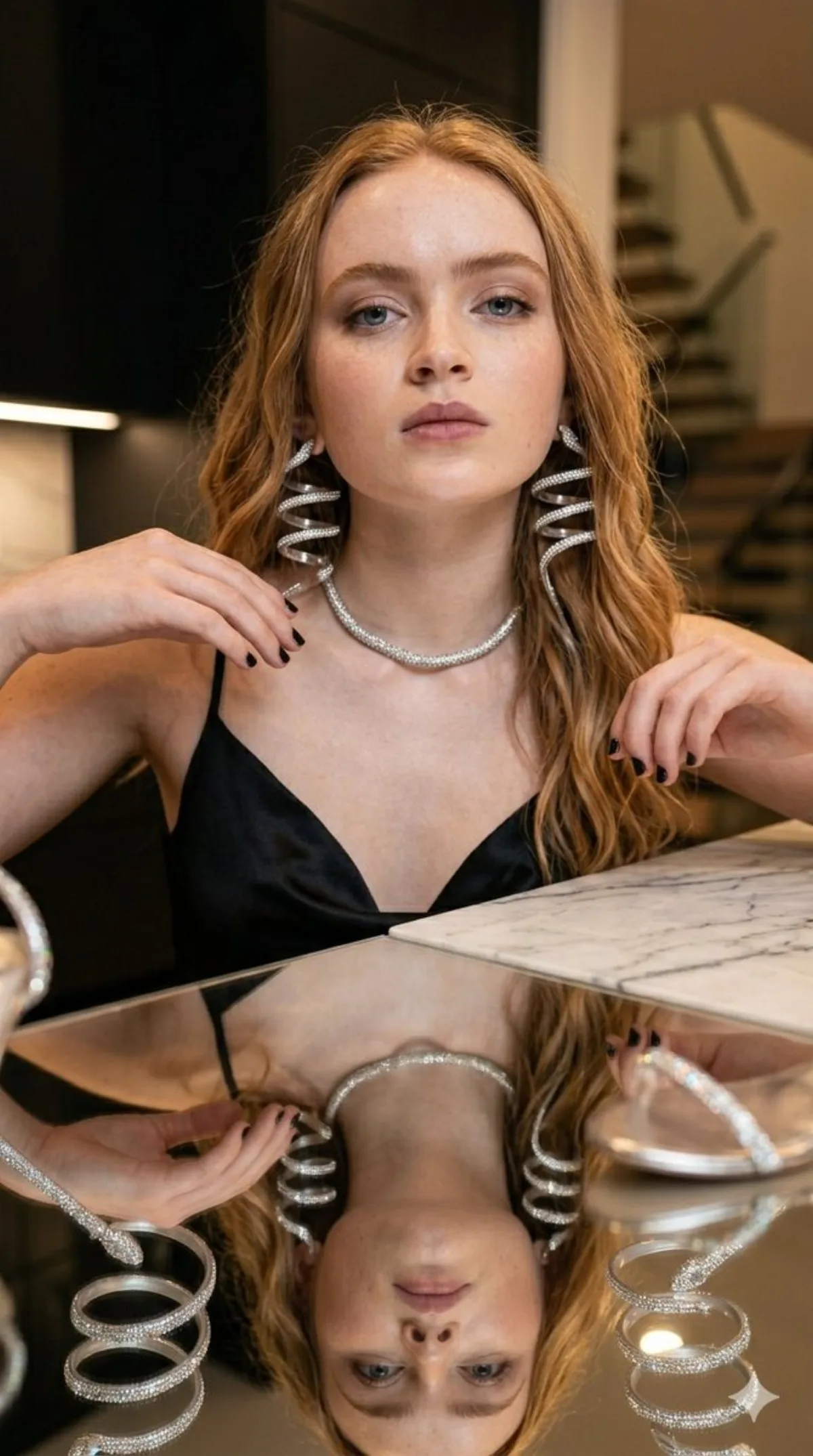 Glamorous Woman in Black Slip Dress on Marble Counter