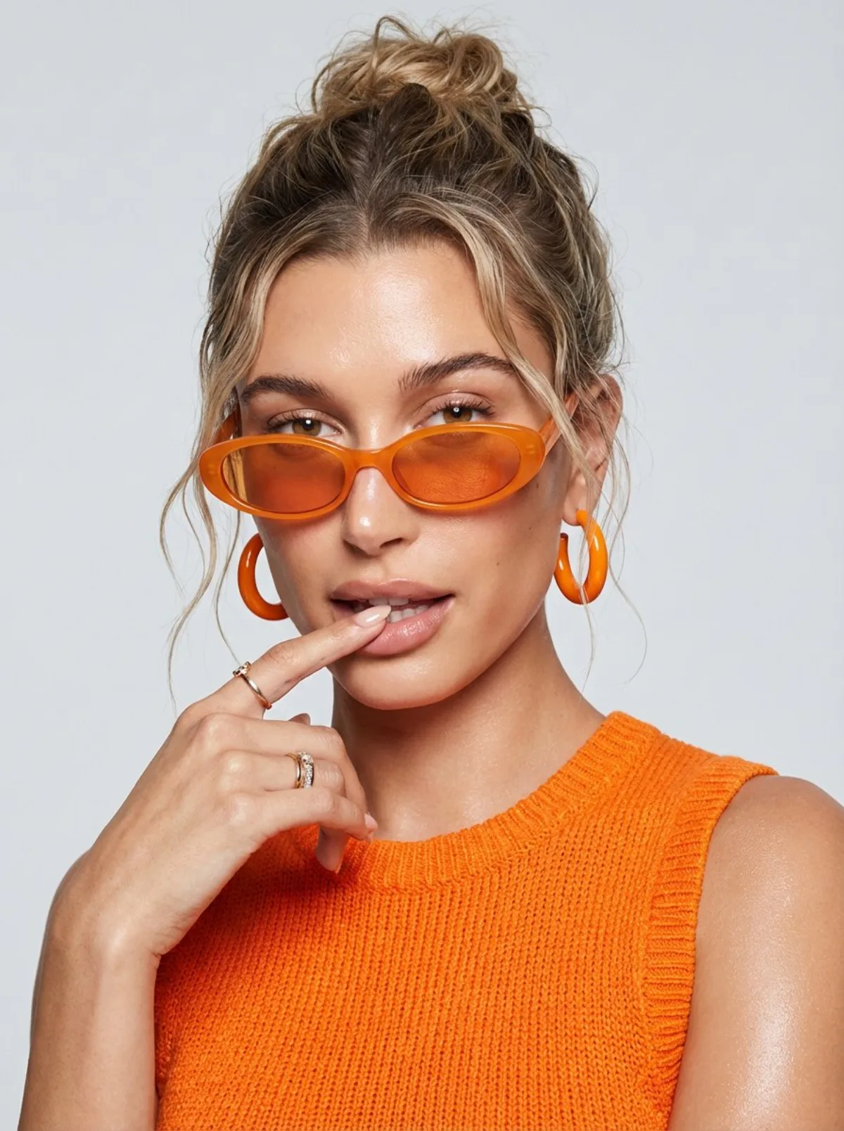 Stylized Playful Orange Fashion Portrait with Sunglasses