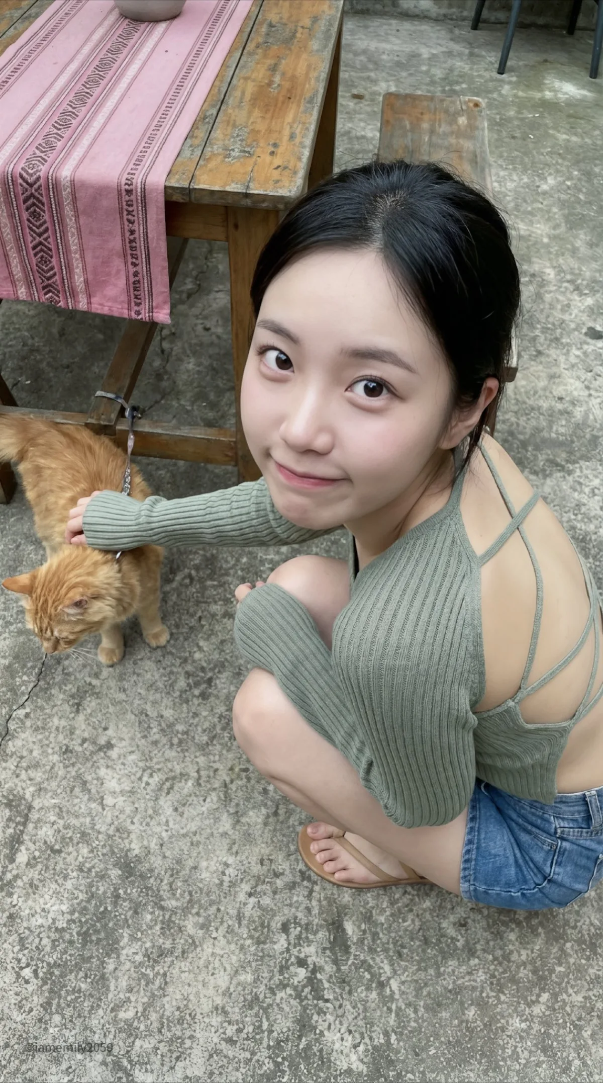 Young Asian Woman Squatting in Concrete Courtyard