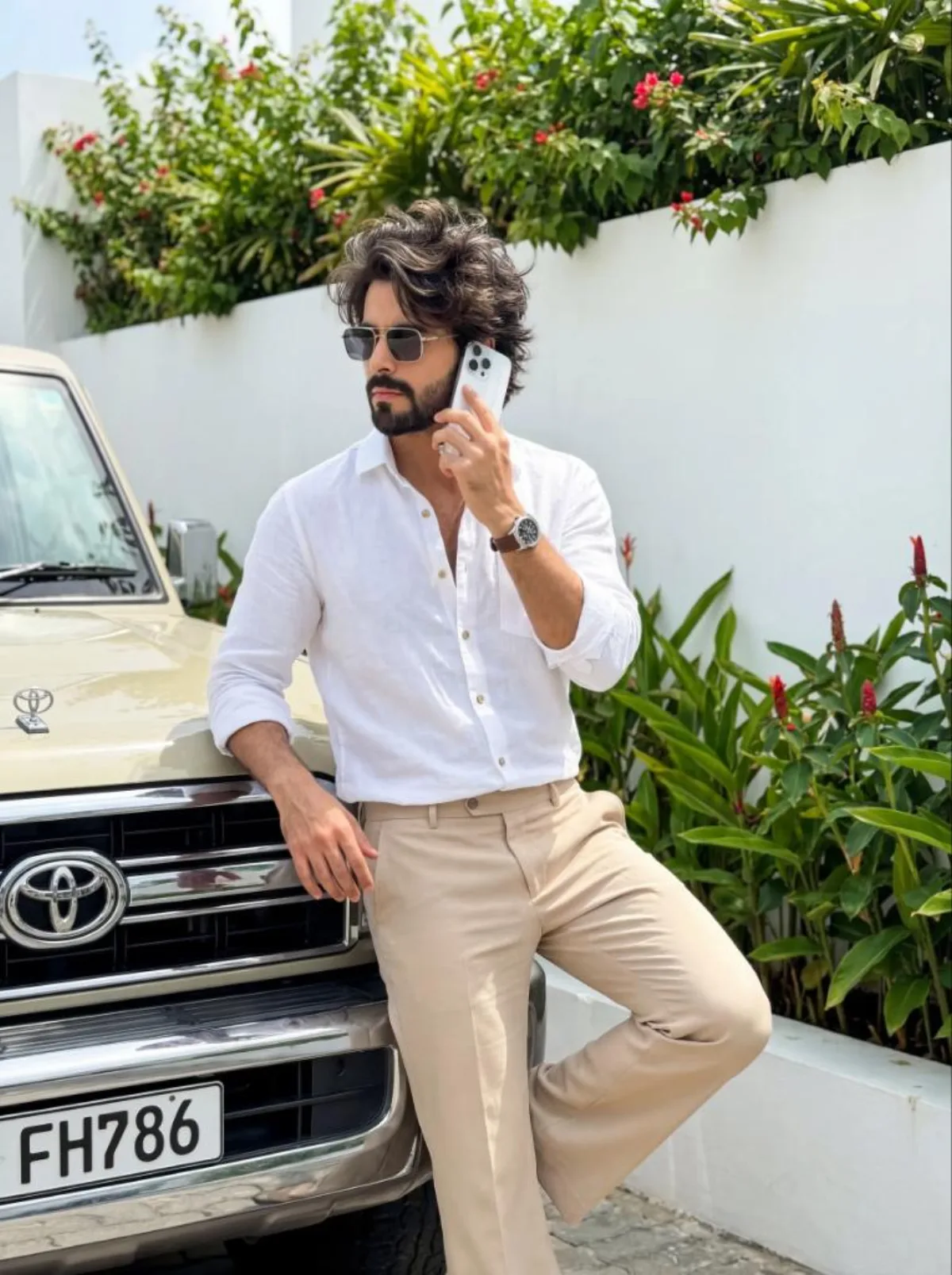 Stylish Boy with iPhone Leaning on Land Cruiser: A Curated Take